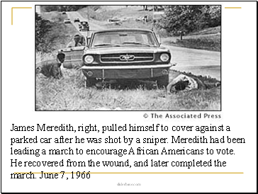James Meredith, right, pulled himself to cover against a parked car after he was shot by a sniper. Meredith had been leading a march to encourage African Americans to vote. He recovered from the wound, and later completed the march. June 7, 1966