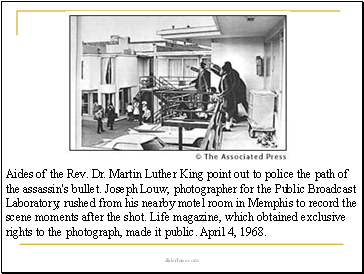 Aides of the Rev. Dr. Martin Luther King point out to police the path of the assassin's bullet. Joseph Louw, photographer for the Public Broadcast Laboratory, rushed from his nearby motel room in Memphis to record the scene moments after the shot. Life magazine, which obtained exclusive rights to the photograph, made it public. April 4, 1968.